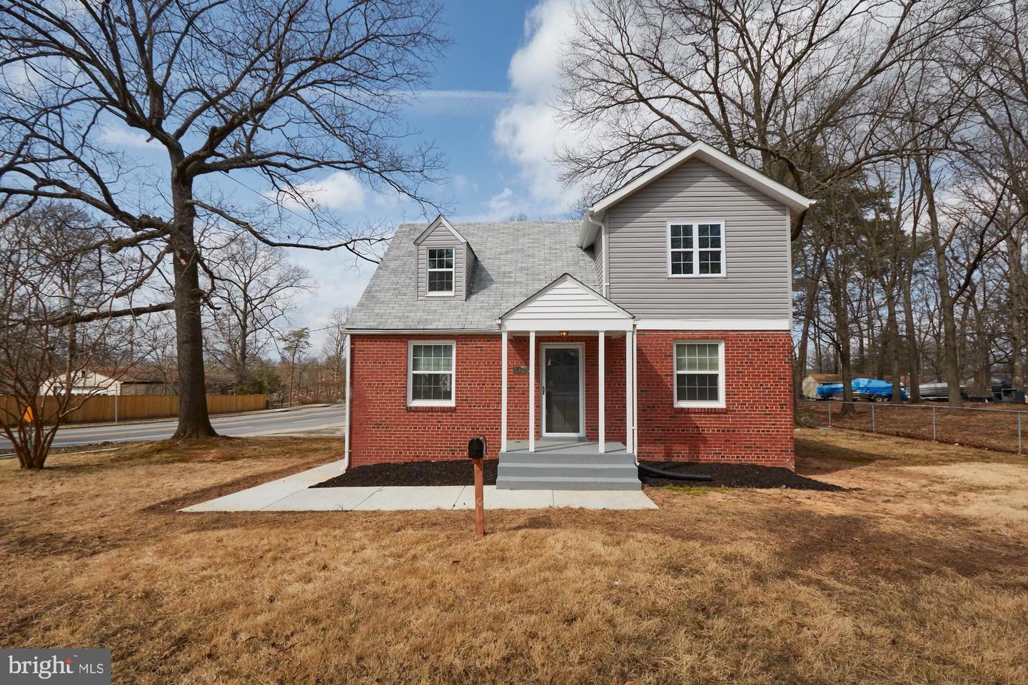 Completed second-floor addition — full second floor added to brick Cape Cod home