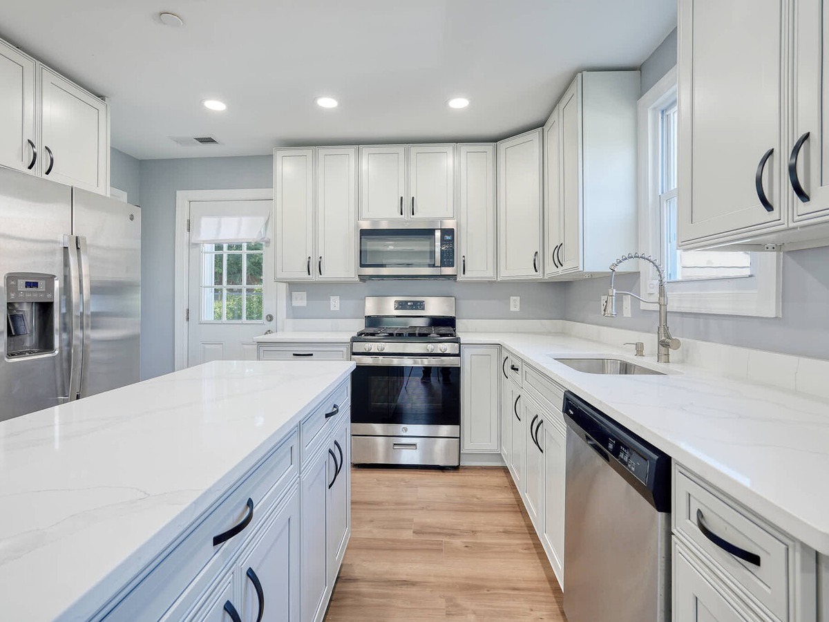 White quartz kitchen remodel with waterfall island